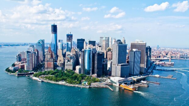 Aerial view of Manhattan cityscape with skyscrapers and water surrounding the borough