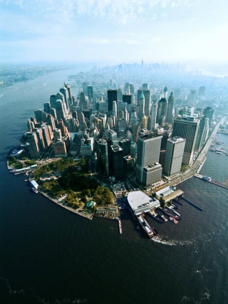 Aerial view of Manhattan cityscape with skyscrapers and waterfront in clear daylight