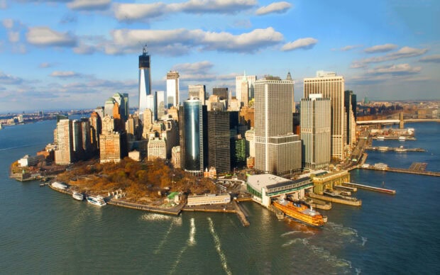 Aerial view of Manhattan cityscape with skyscrapers and waterfront on a clear day