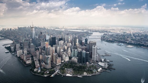 Aerial view of Manhattan skyline with iconic buildings and rivers surrounding the island