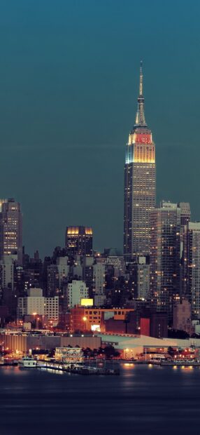 Illuminated Manhattan skyline with skyscrapers at night including the iconic Empire State building
