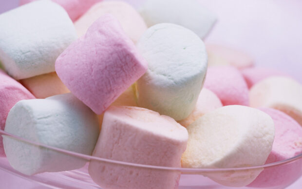 Soft colorful marshmallow in pastel shades stacked in a clear bowl