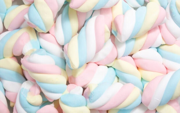 Colorful twisted marshmallow sweets in pastel shades of pink yellow and blue