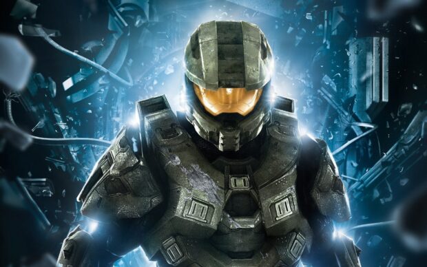 Master Chief in armored suit standing in futuristic environment with shattered glass and blue light