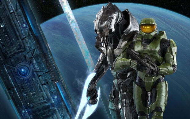 Master Chief standing with a Sangheili warrior in front of a space station and planet Earth in the background