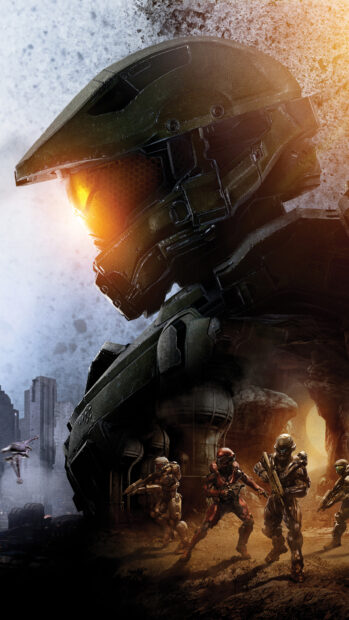 Master Chief in futuristic armor leading a team in a battle scene on an alien planet