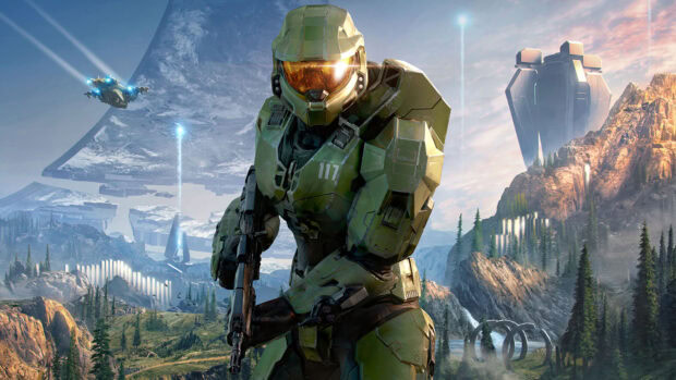 Master Chief stands ready in green armor on an alien landscape with futuristic structures and a spaceship in the sky