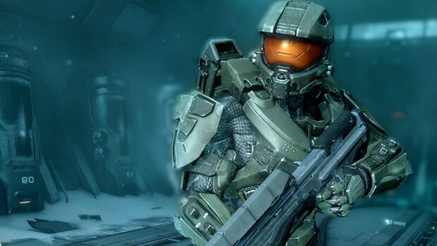 Master Chief in green armor holding a weapon in a futuristic environment