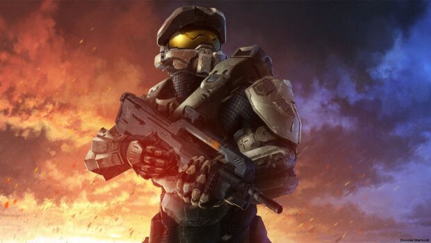 Master Chief soldier in futuristic armor holding a weapon against a fiery sky background