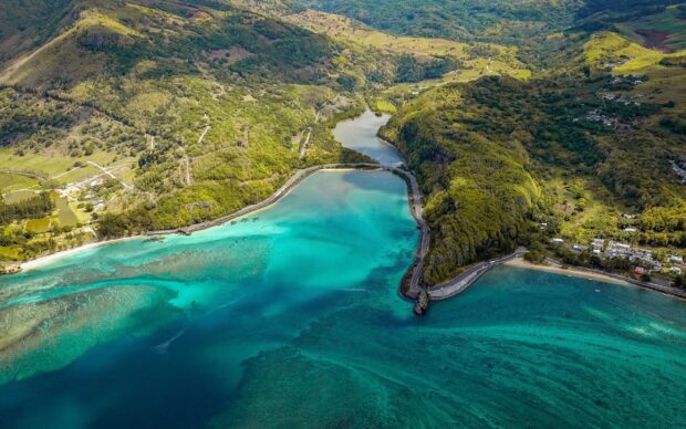 Aerial view of Mauritius Island turquoise water and lush green hills landscape