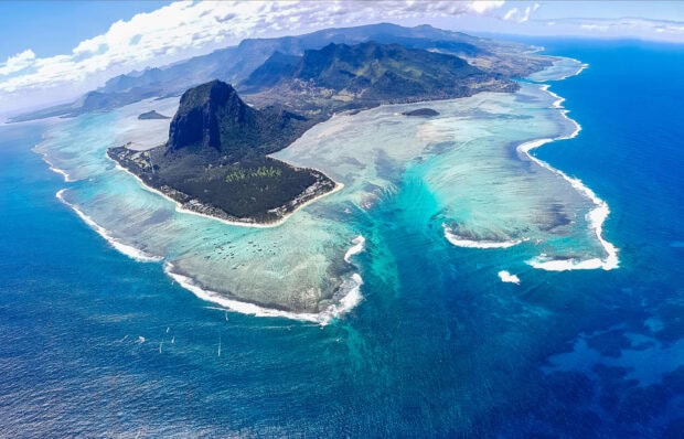 Aerial view of Mauritius Island with turquoise waters and lush mountainous landscape