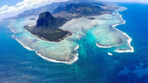 Aerial view of Mauritius Island with clear turquoise waters and lush mountainous landscape