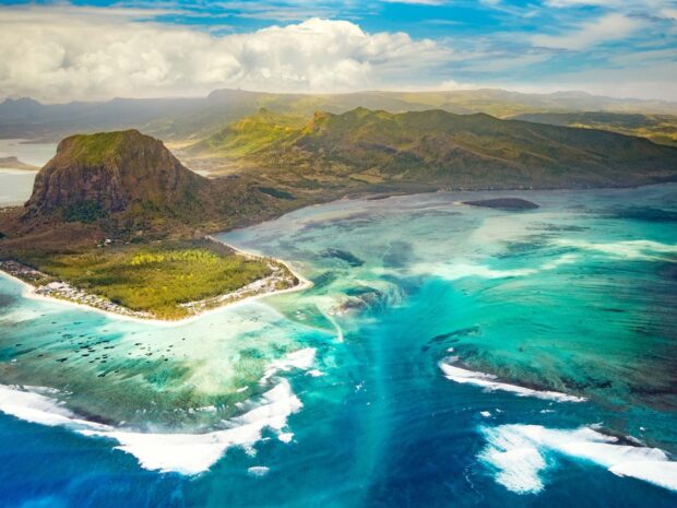 Aerial view of Mauritius island with lush green mountains and turquoise water