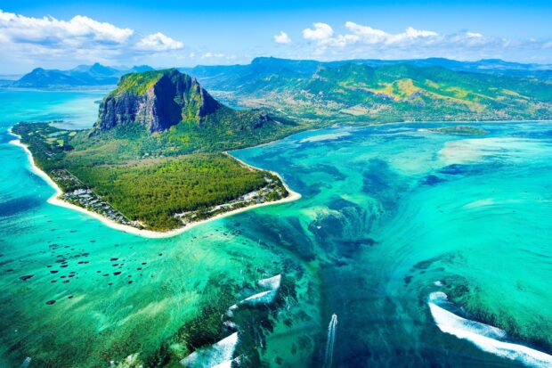 Aerial view of turquoise waters and lush mountain landscape on Mauritius Island
