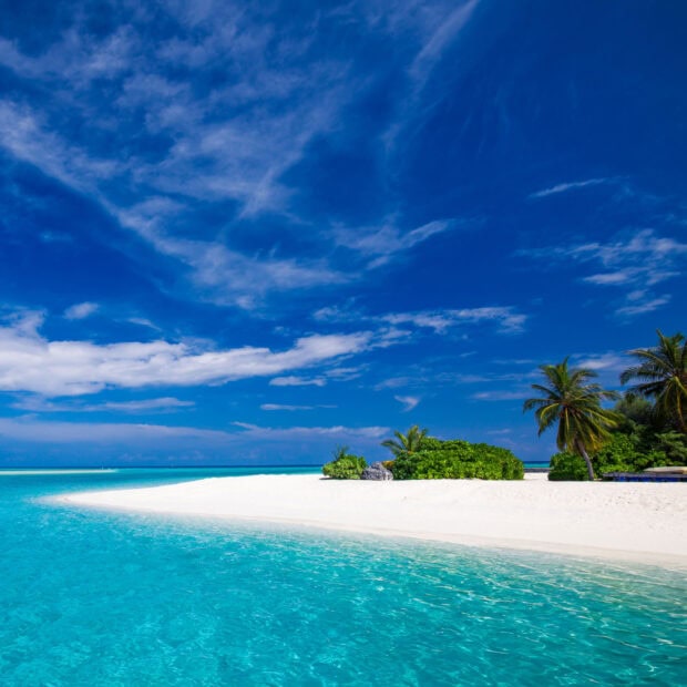 Crystal clear turquoise water and white sandy beach on Mauritius Island