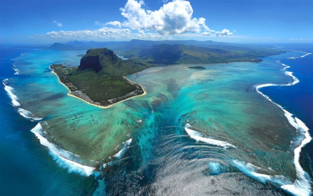 Aerial view of Mauritius Island coastline with vibrant blue waters and green landscapes