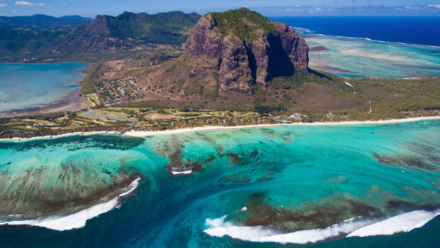 Aerial view of Mauritius Island turquoise waters and mountain landscape in pristine nature