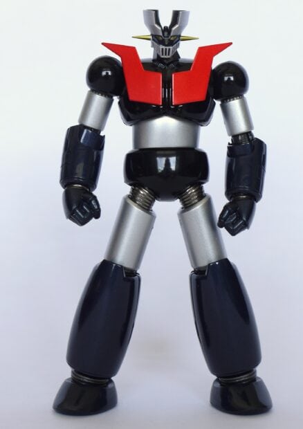 A detailed Mazinger Z robot figure standing tall with red chest panels and metallic limbs