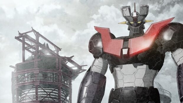 Mazinger Z robot standing tall near industrial structure in a cloudy sky background