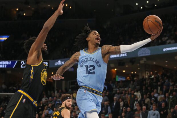 Memphis Grizzlies player number 12 making a basketball layup during a game against the Golden State Warriors