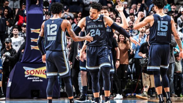 Memphis Grizzlies players celebrating during an NBA game with Morant and Clarke on the court