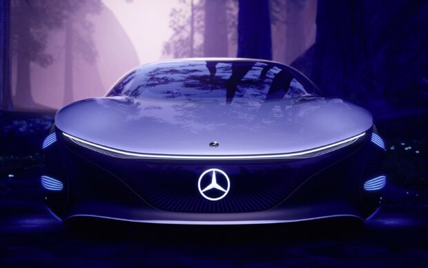 A futuristic Mercedes Benz concept car front view with illuminated emblem in a dark forest setting
