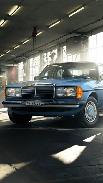 Classic Mercedes Benz car parked inside a garage with sunlight streaming through windows