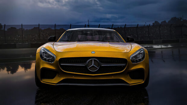 Front view of a yellow Mercedes Benz sports car with rain droplets on the hood
