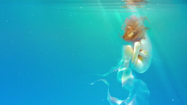 A serene underwater scene featuring a mermaid curled up in clear blue water with flowing hair and fins