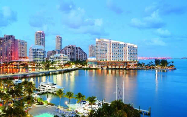 Miami Beach skyline with high rise buildings and yachts on a clear evening