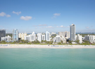 Miami Beach skyline with clear blue sky over high rise buildings and sandy beach