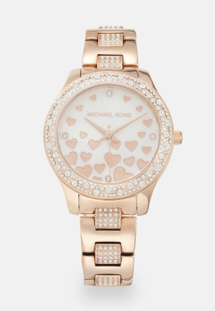 A Michael Kors watch with rose gold hearts and crystal accents on the band and face