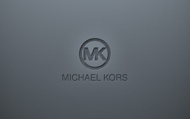 Michael Kors logo embossed on a textured gray surface featuring Michael Kors