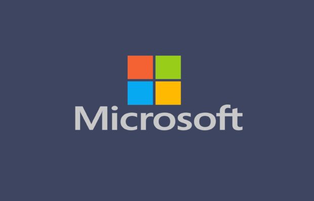 Microsoft logo with colorful squares on dark blue background for desktop design