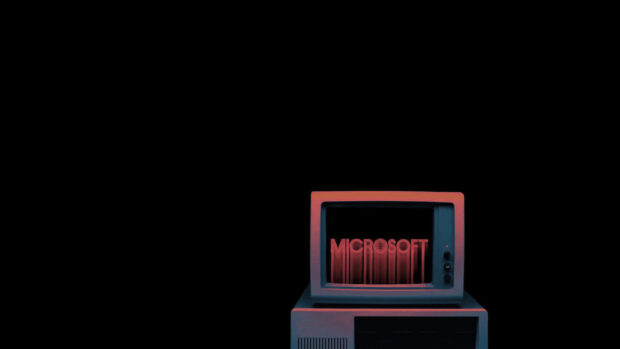 The retro desktop computer displaying the word Microsoft in red letters on the screen
