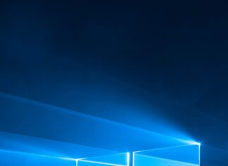 Blue light shining through a Microsoft logo window on a dark background