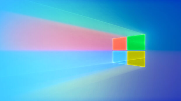 Colorful Microsoft logo emitting light beams on a blue gradient background