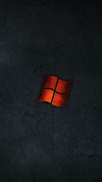 Red Microsoft logo symbol with dark textured background on black surface