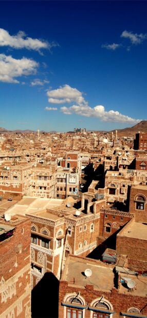 Traditional Middle East architecture with detailed brick buildings under a clear blue sky