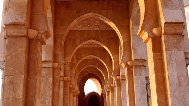 Ancient Middle East architecture with arches and columns in warm sunlight