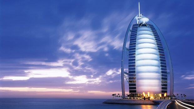 Iconic sail shaped building in the Middle East with a twilight sky and calm sea