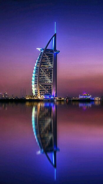 Modern architecture of Middle East reflected in calm water at dusk