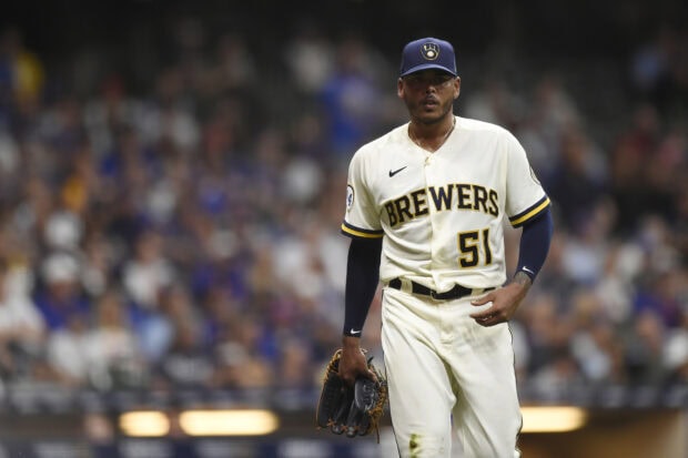 Milwaukee Brewers player standing on the field in a white uniform with number 51