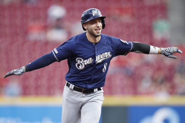 A Milwaukee Brewers player celebrating with arms outstretched during a baseball game