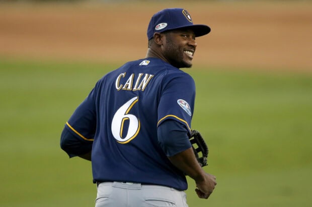 Milwaukee Brewers player Cain smiling on the field wearing jersey number 6