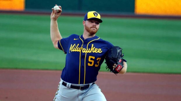 Milwaukee Brewers player pitching in a game wearing team uniform and cap