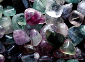 A close up view of colorful minerals with polished surfaces and natural patterns