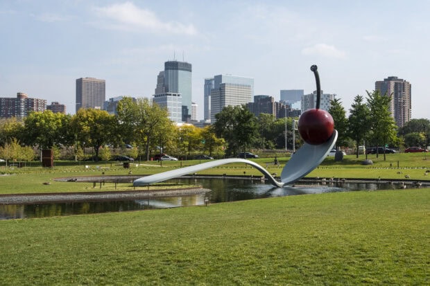 Spoonbridge and Cherry sculpture with Minneapolis skyline and park trees in the background