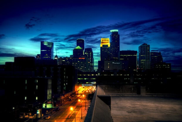 Twilight cityscape of Minneapolis with illuminated skyscrapers and night sky