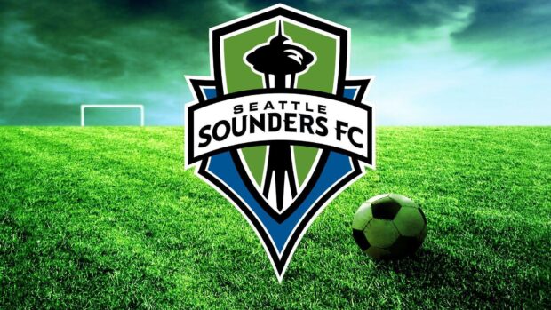 Seattle Sounders logo on green soccer field with ball and goal in the background